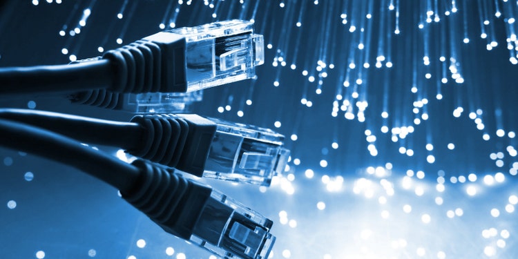 an image of ethernet cables with blue fiber optic lights in the background